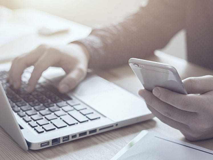 man use laptop and smartphone